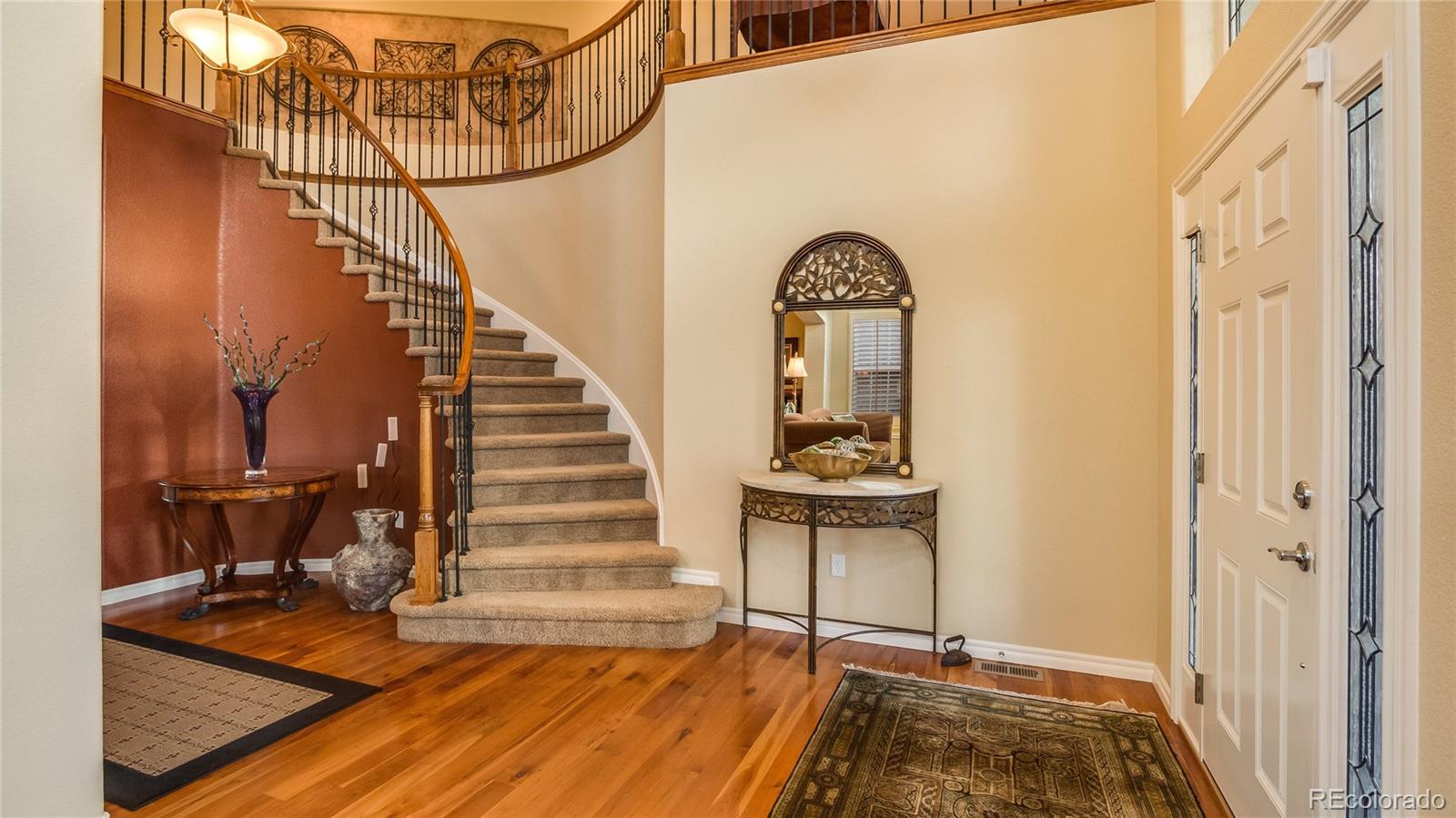 5310 Streambed Trail Parker, CO 80134 - Photo 4 of 35 a view of entryway and hall with wooden floor