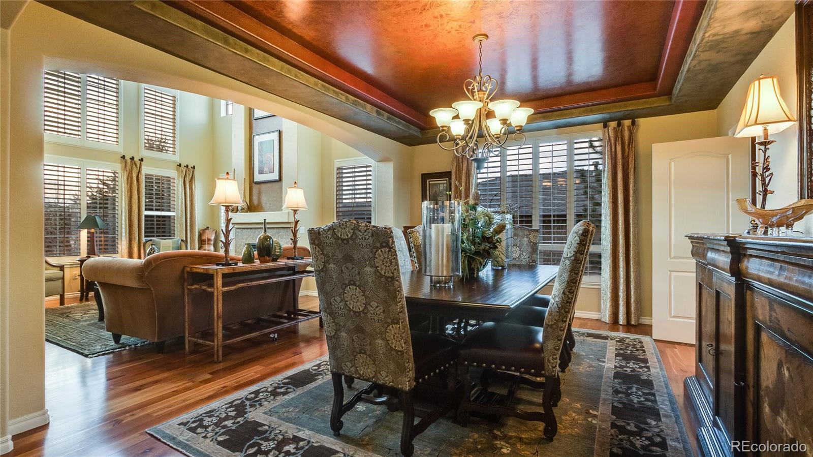 5310 Streambed Trail Parker, CO 80134 - Photo 8 of 35 a dining room with furniture a chandelier and wooden floor