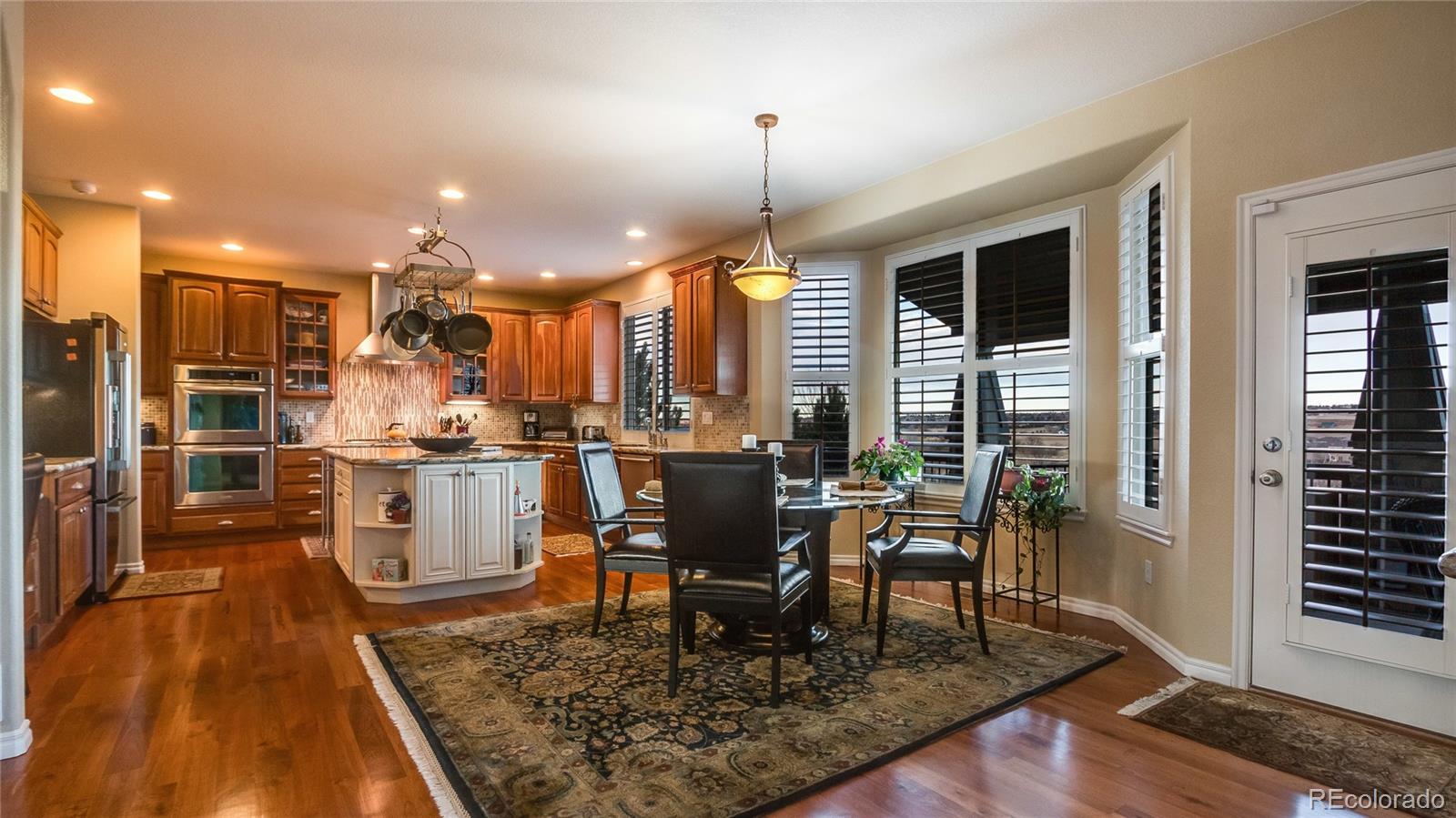 5310 Streambed Trail Parker, CO 80134 - Photo 9 of 35 a kitchen with a table chairs and entryway