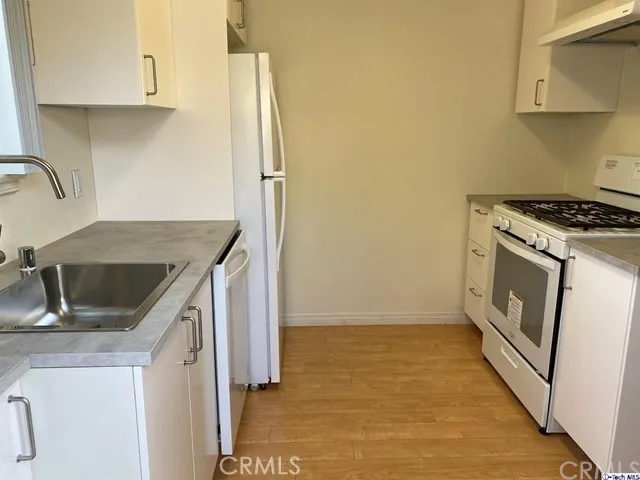 a kitchen that has a sink and a stove