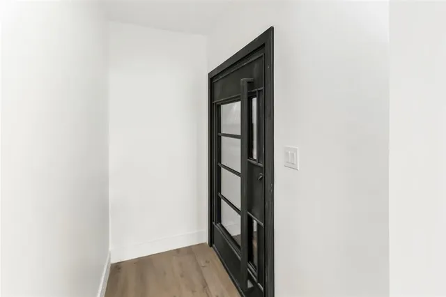 a view of hallway with wooden floor