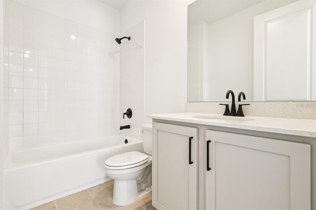2298 Broadbrook Drive St. Cloud, FL 34771 - Photo 20 of 40 a bathroom with a sink a toilet and a bathtub