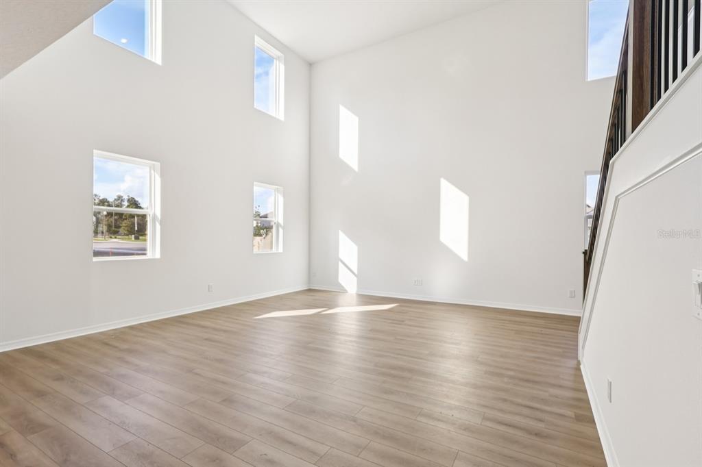 2298 Broadbrook Drive St. Cloud, FL 34771 - Photo 6 of 40 a view of an empty room with wooden floor and a window