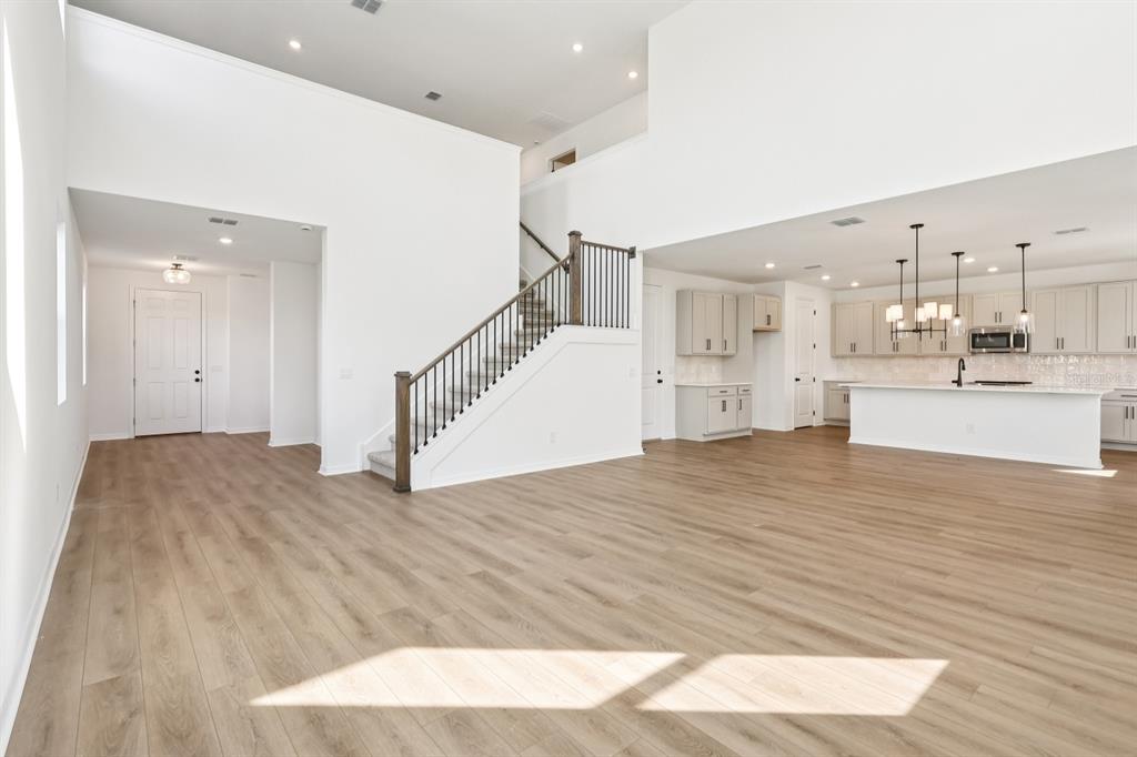 2298 Broadbrook Drive St. Cloud, FL 34771 - Photo 8 of 40 a view of a kitchen and kitchen counter top space with wooden floor