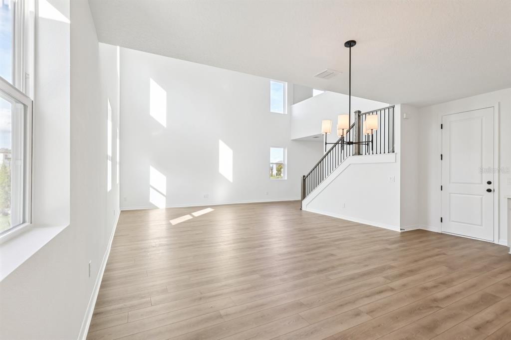 2298 Broadbrook Drive St. Cloud, FL 34771 - Photo 9 of 40 a view of empty room with wooden floor and fan