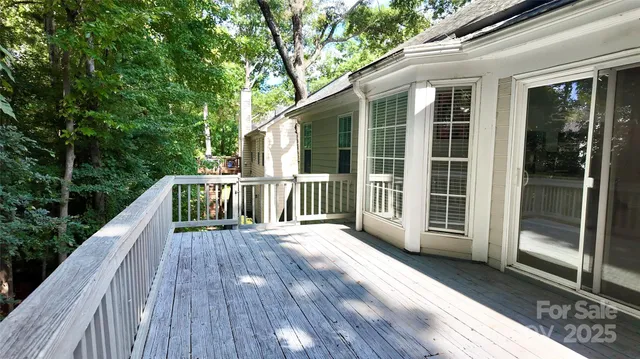 a view of a porch with wooden floor and roof
