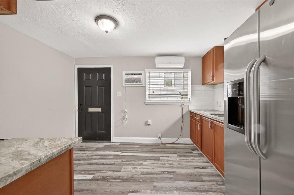 1511 Scharpe Street, Unit 2 Houston, TX 77023 - Photo 6 of 27 a kitchen with stainless steel appliances granite countertop a refrigerator and a sink
