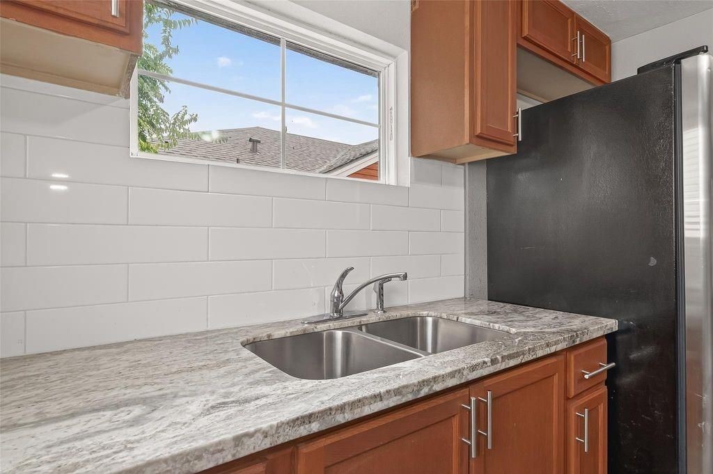 1511 Scharpe Street, Unit 2 Houston, TX 77023 - Photo 9 of 27 a kitchen with stainless steel appliances granite countertop a sink a stove and cabinets
