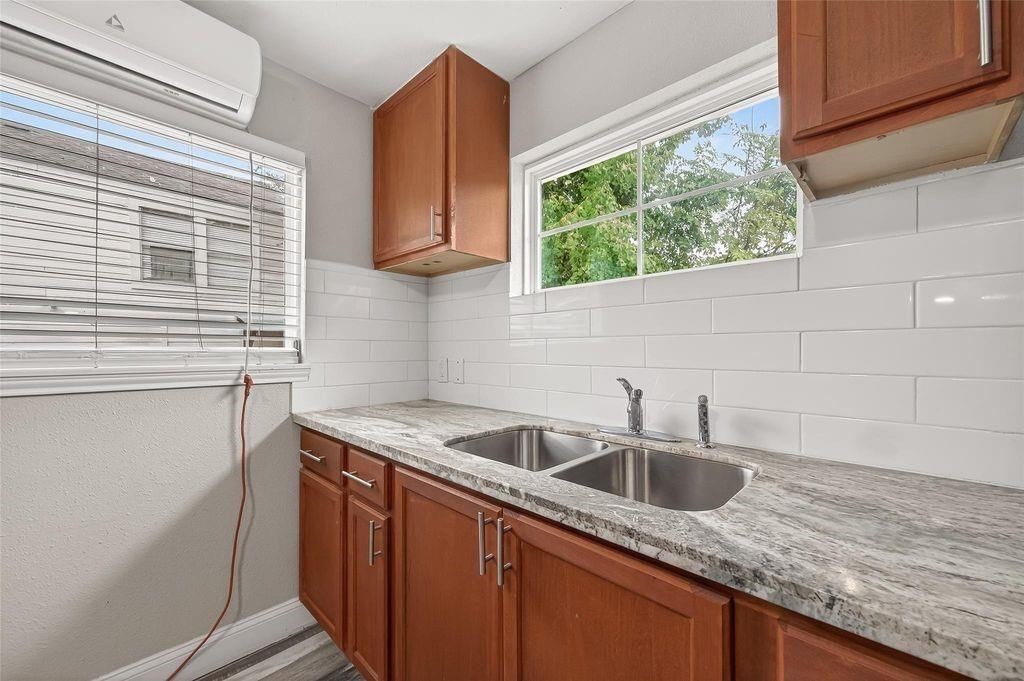 1511 Scharpe Street, Unit 2 Houston, TX 77023 - Photo 10 of 27 a kitchen with stainless steel appliances granite countertop a sink a stove and a window