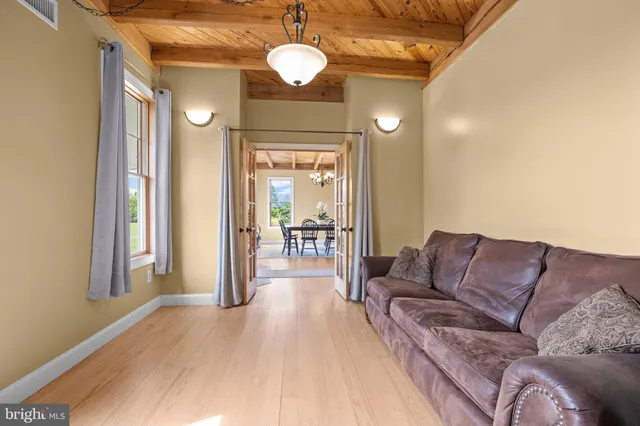 a kitchen with granite countertop a table chairs stove and cabinets