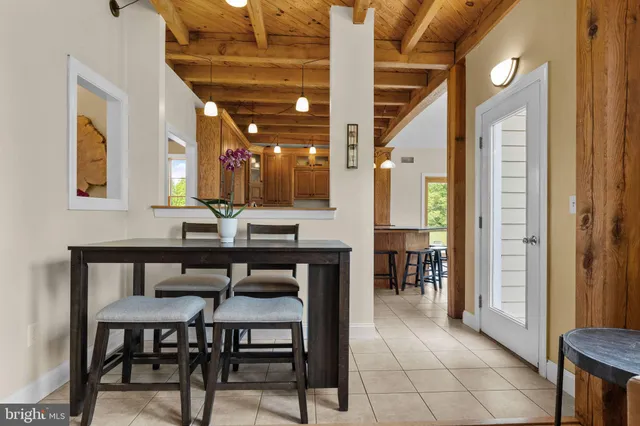 a view of a house with a small yard and wooden fence