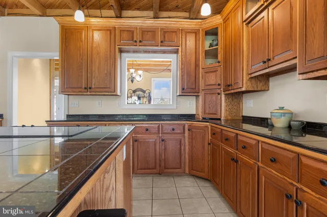 a spacious bedroom with a bed and a dresser