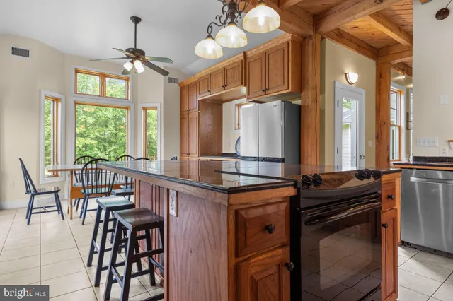 a view of a livingroom with lounge chair and a ceiling fan