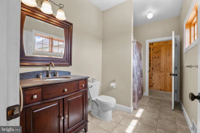 a view of a hallway with wooden floor and stairs