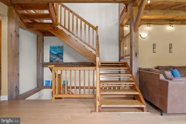 a living room with furniture and a book shelf