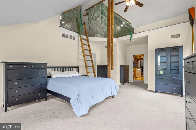 a view of white house with a big yard and potted plants