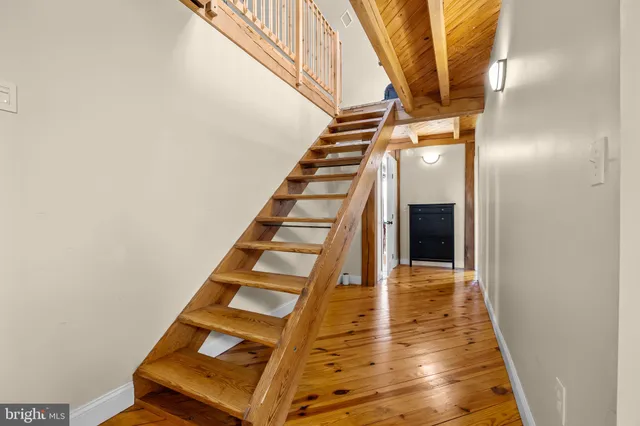 swimming pool view with a garden and seating area