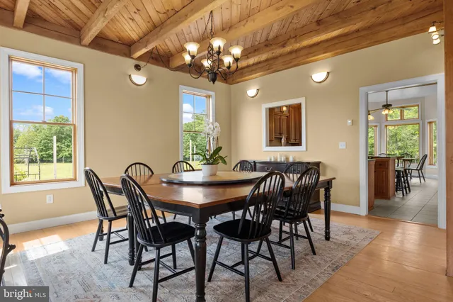 a living room with furniture a table and a large window