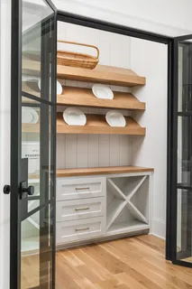 a kitchen with stainless steel appliances granite countertop a sink a stove and a wooden floors