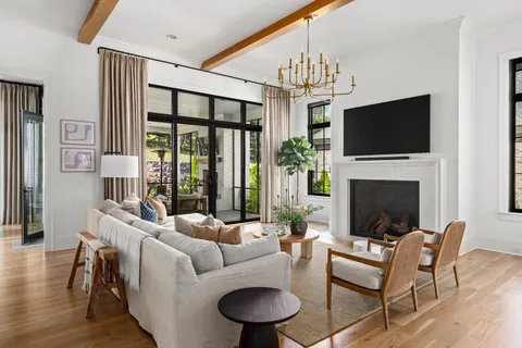 a kitchen with stainless steel appliances a stove a sink and white cabinets