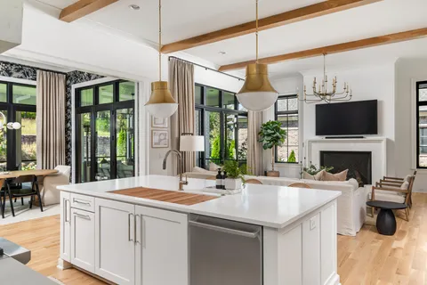 a kitchen with a sink a refrigerator and window