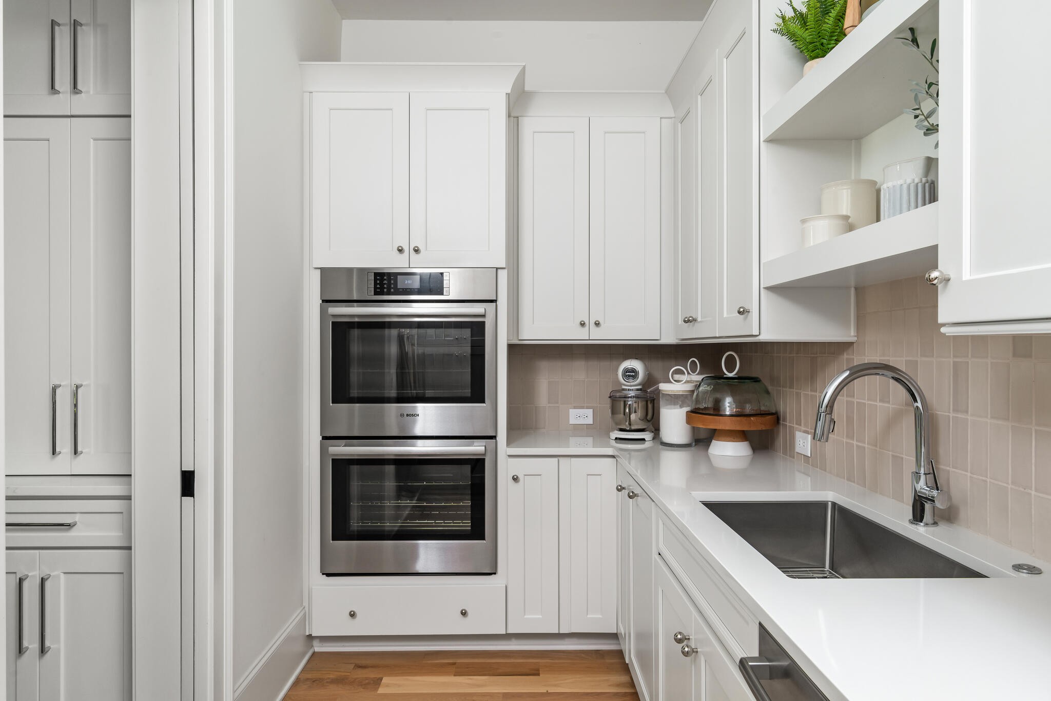 9021 Passiflora College Grove, TN 37046 - Photo 29 of 84 a kitchen with stainless steel appliances a stove a sink and white cabinets