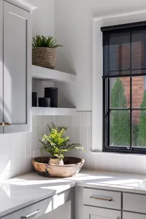 a living room with furniture and large windows