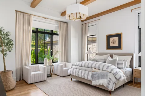 a bedroom with a large bed and a large window