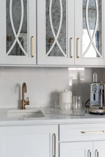 a living room with furniture a large window and a chandelier