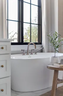 a living room with fireplace furniture and a large window