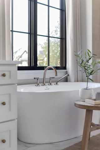 a living room with fireplace furniture and a large window