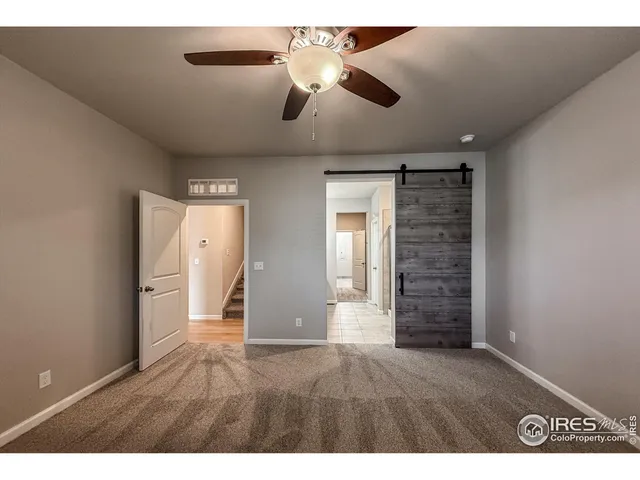an empty room with closet and windows