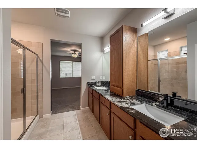 a bathroom with a double vanity sink and mirror