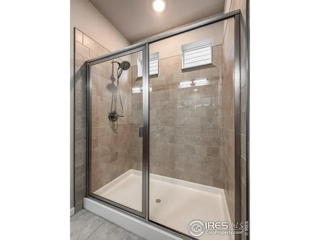 a bathroom with a glass shower door