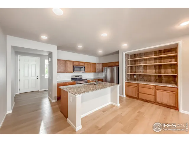 a kitchen with stainless steel appliances a stove and more cabinets
