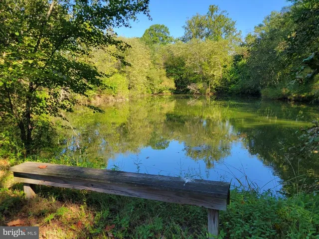 a view of wooden house with a small yard