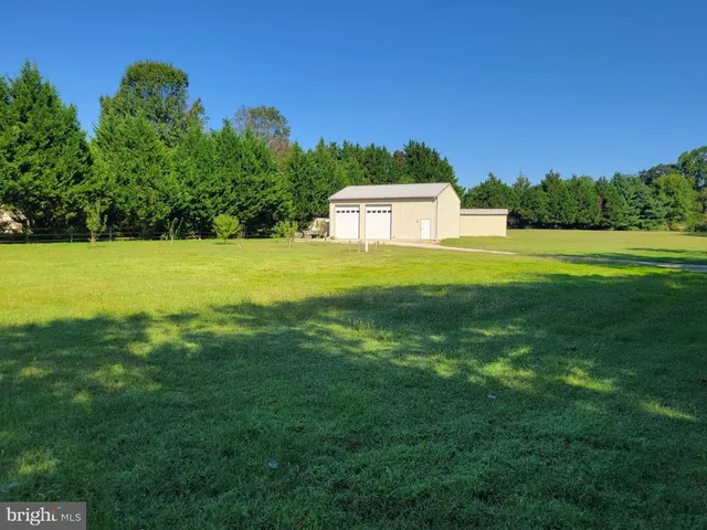 a view of a big yard with an outdoor space and seating area