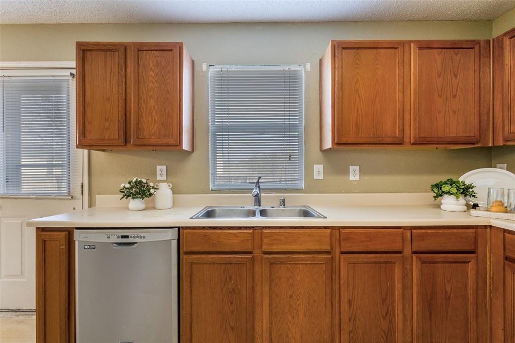 2532 Timberbrook Trail McKinney, TX 75071 - Photo 13 of 32 a kitchen with a sink cabinets and a window