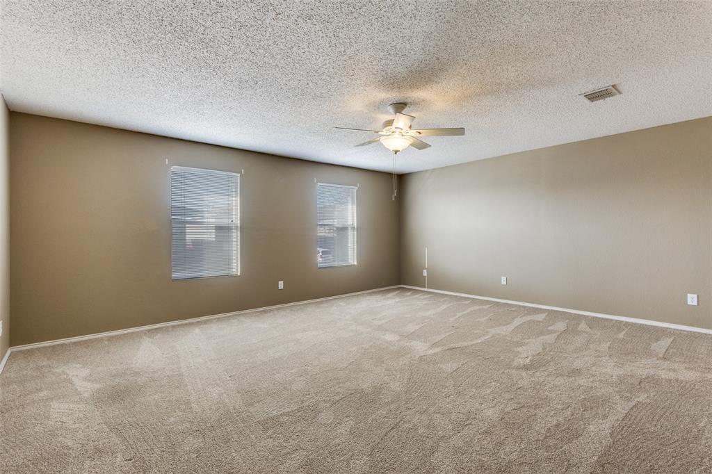 2532 Timberbrook Trail McKinney, TX 75071 - Photo 22 of 32 an empty room with windows and chandelier fan