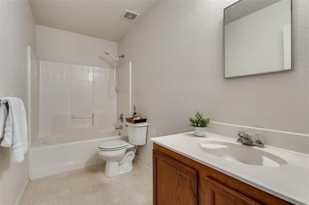 2532 Timberbrook Trail McKinney, TX 75071 - Photo 28 of 32 a bathroom with a granite countertop sink toilet and shower