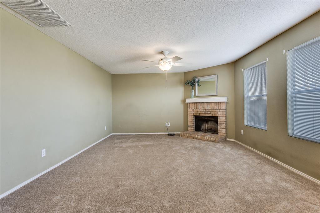 2532 Timberbrook Trail McKinney, TX 75071 - Photo 7 of 32 a view of an empty room with a fireplace and a window