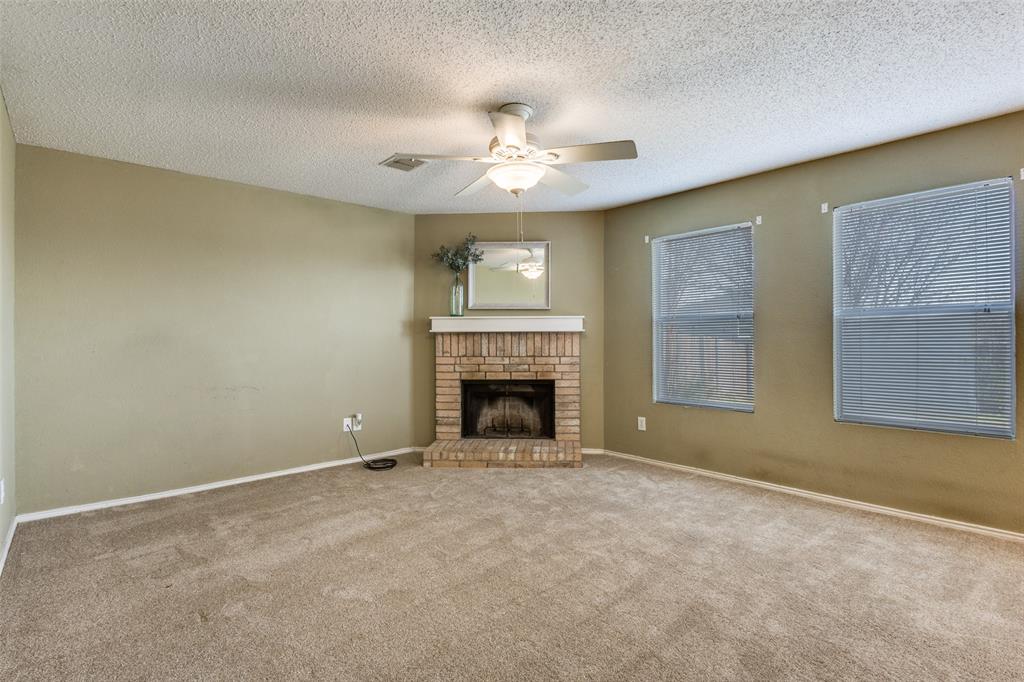 2532 Timberbrook Trail McKinney, TX 75071 - Photo 8 of 32 a view of an empty room with a fireplace and a window
