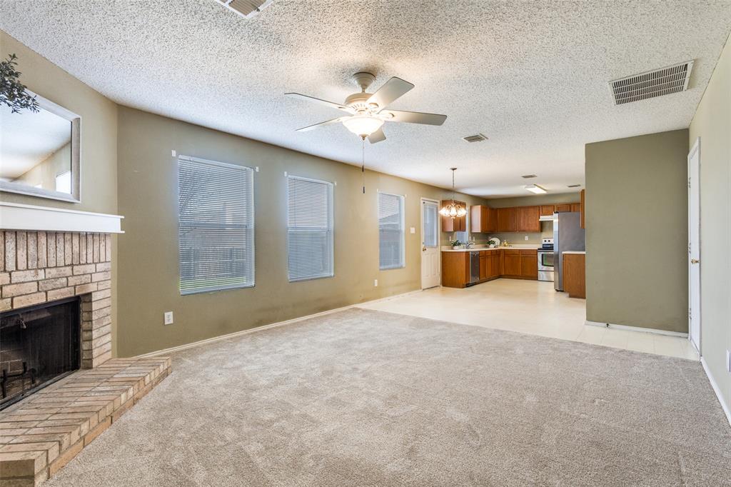 2532 Timberbrook Trail McKinney, TX 75071 - Photo 10 of 32 a big room with chandelier and fireplace