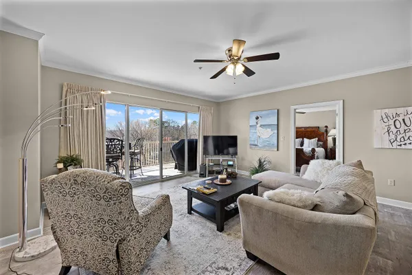 a living room with furniture and a wooden floor