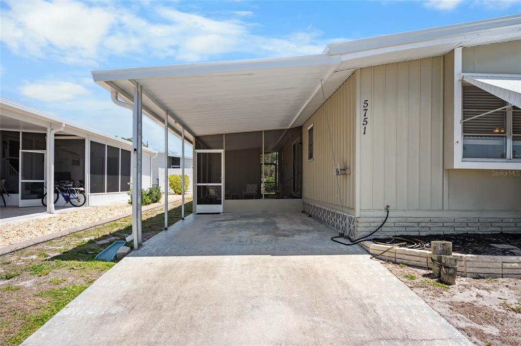 5751 Hyacinth Road Venice, FL 34293 - Photo 28 of 44 a view of a house with backyard porch and sitting area