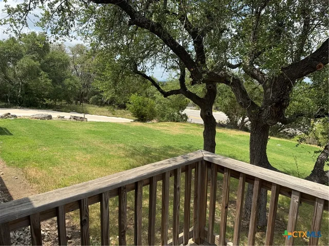 a view of a wooden deck with a yard