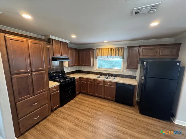 a white toilet sitting next to a bath tub