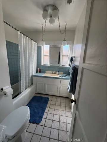 a kitchen with a sink a window and chairs