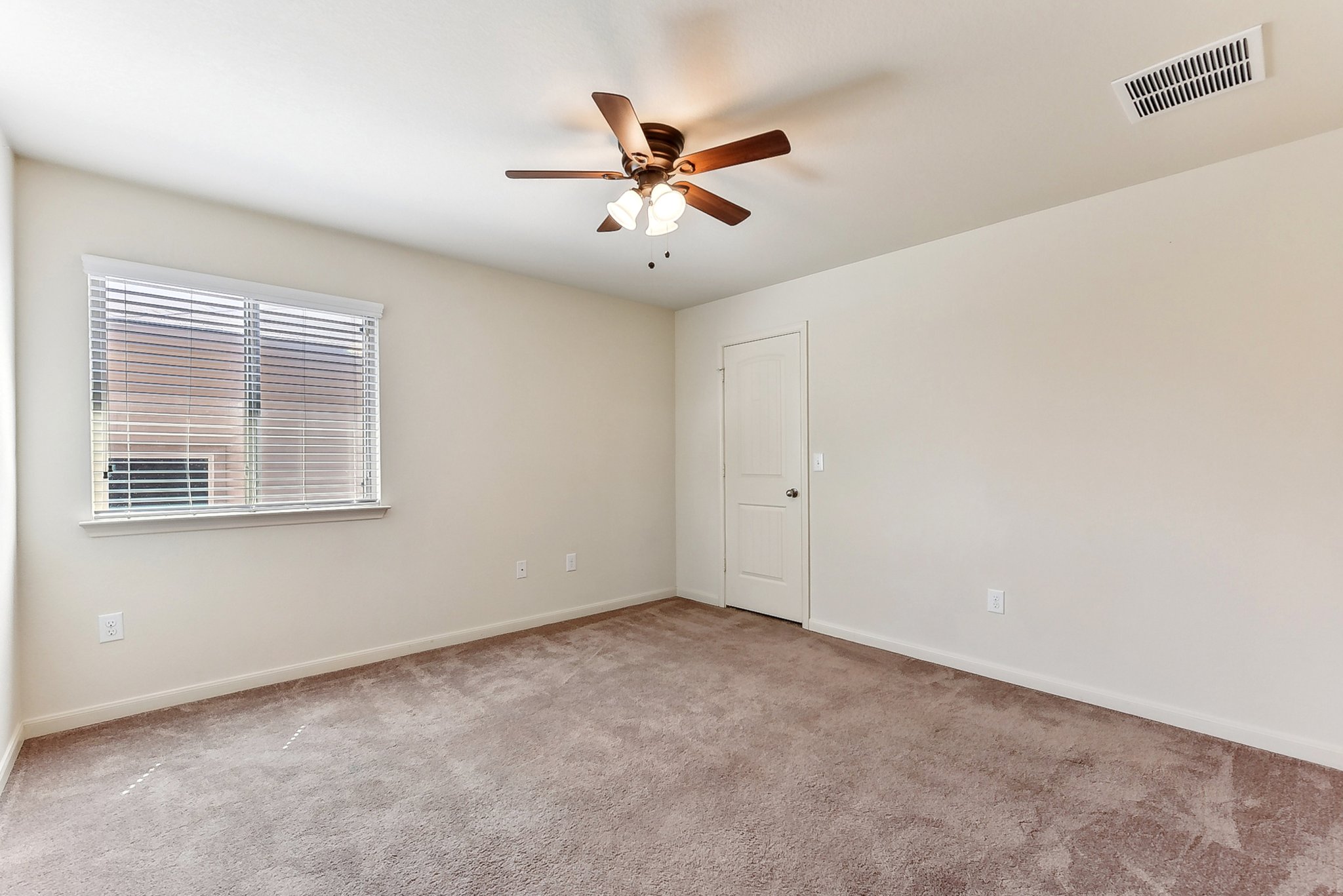 310 Potters Peak Way Georgetown, TX 78626 - Photo 12 of 21 Neutral-toned room featuring a ceiling fan with integrated lighting, a window with horizontal blinds, a white door, and soft carpet flooring