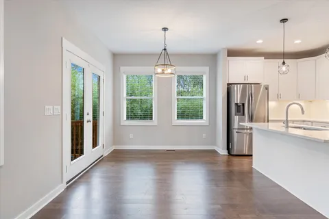 a view of a kitchen with a stove wooden floor and a window
